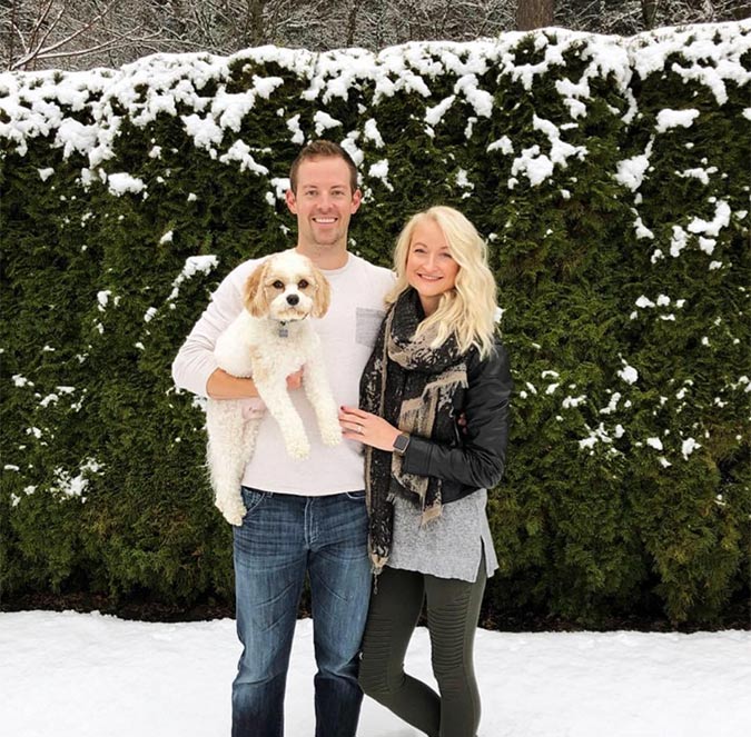 Drs. Nick and Whitney Forsythe standing outside with their dog