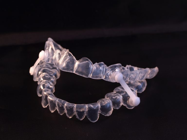 Clear oral appliance on a black background