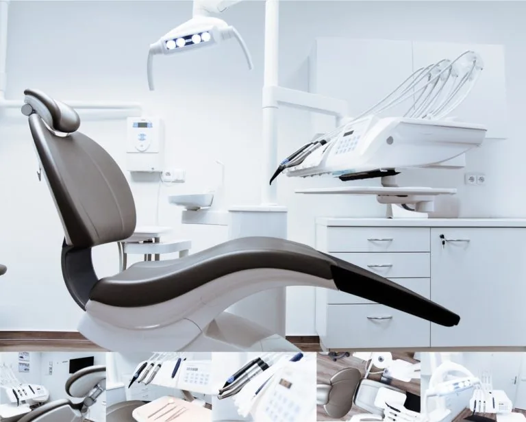 Modern dental office with a central dental chair, overhead light, and nearby instruments, including a monitor. White cabinetry provides a clean, organized background.
