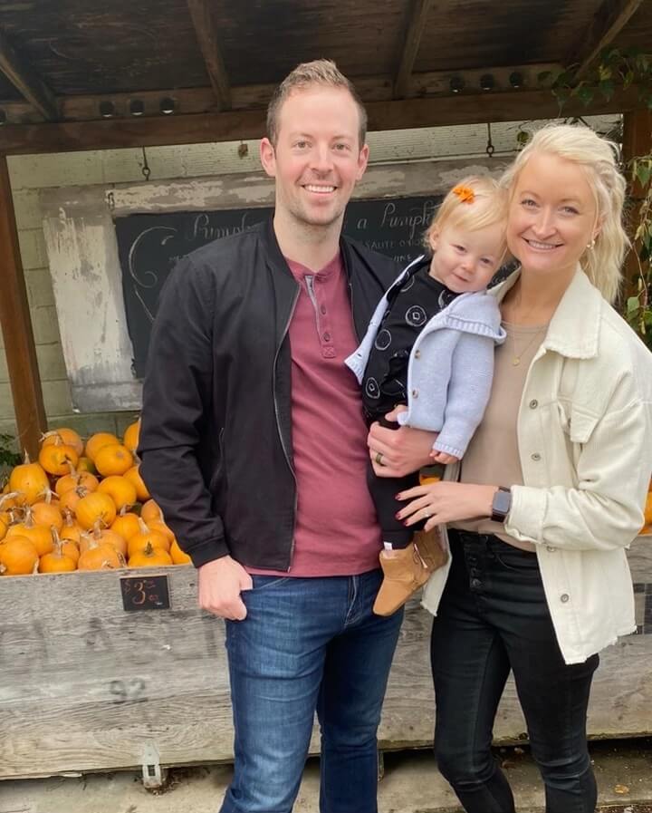 Dr. Whitney Forsythe of Mount Vernon Smile Design holding her baby standing next to her husband Dr. Nicholas Forsythe