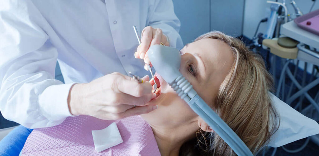 picture of woman receiving sedation in dental chair