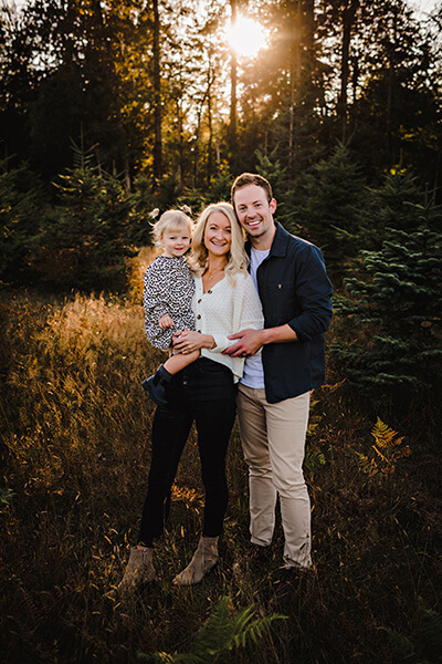 dr whitney and dr nicholas forsythe standing with child